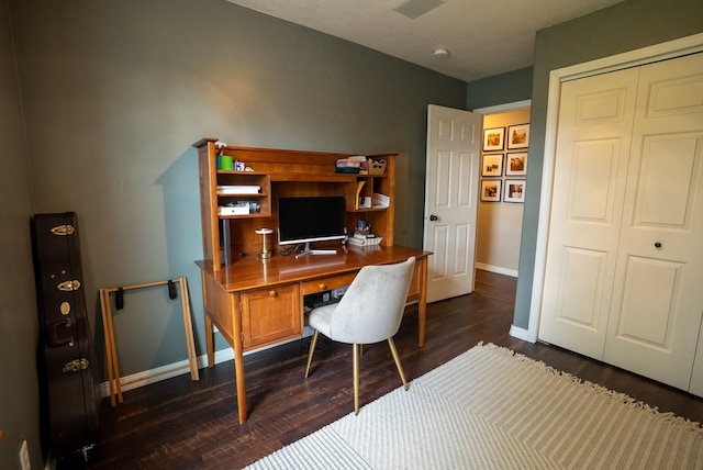 home office with baseboards and dark wood-type flooring