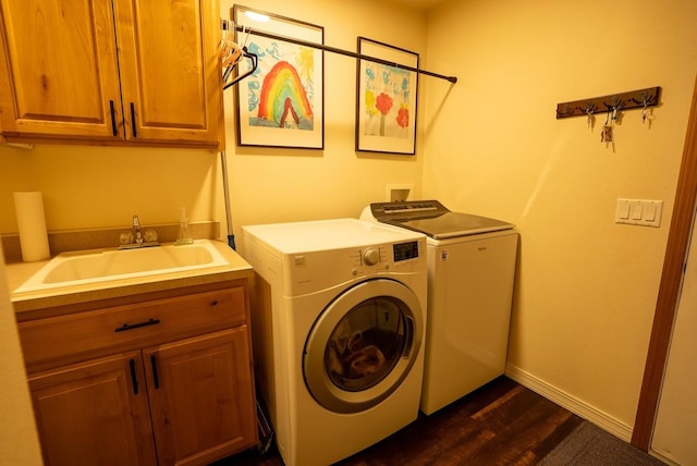 laundry area with cabinet space, separate washer and dryer, dark wood-style flooring, and baseboards