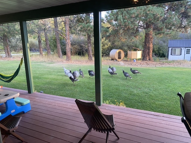 wooden deck featuring a yard