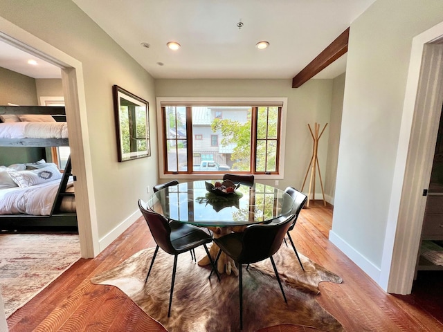 dining area with baseboards, light wood finished floors, and recessed lighting