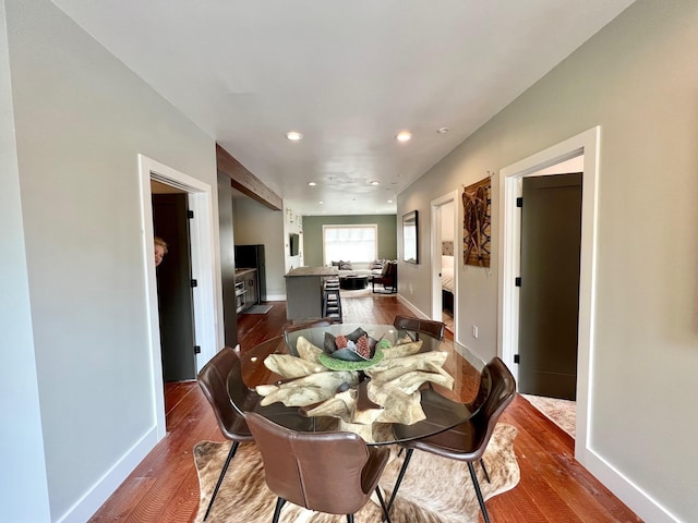 dining space with dark wood finished floors, recessed lighting, and baseboards