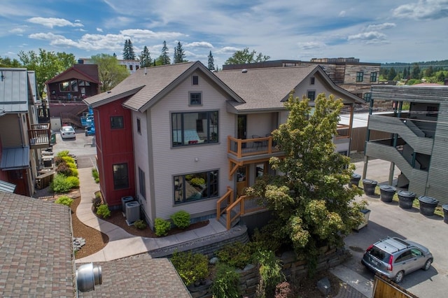 view of front of home with a balcony and central AC unit
