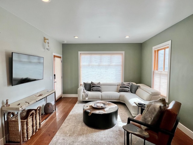 living area with wood finished floors, baseboards, and recessed lighting