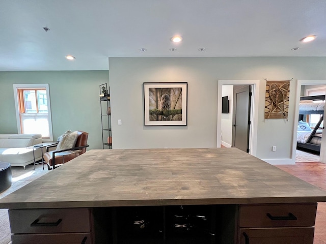 kitchen featuring a center island, dark countertops, open floor plan, and recessed lighting