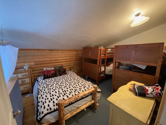 8807 W Fork Rd, Darby, MT 59829 - bedroom featuring log walls, lofted ceiling, and wood finished floors