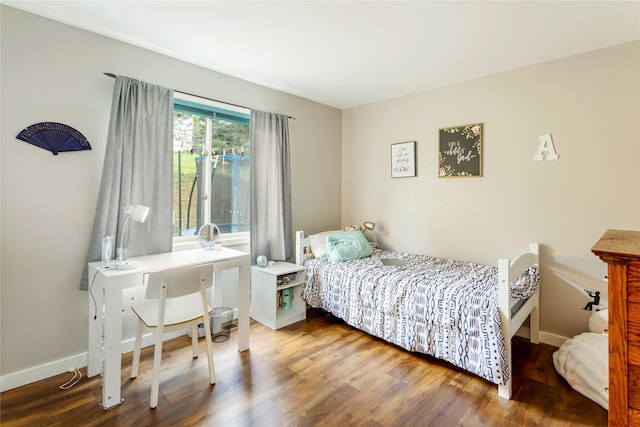 bedroom with wood finished floors and baseboards