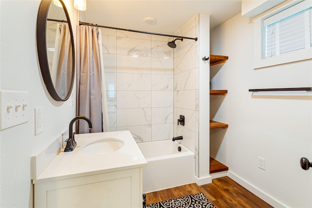 full bathroom featuring wood finished floors, vanity, baseboards, and shower / bath combination with curtain