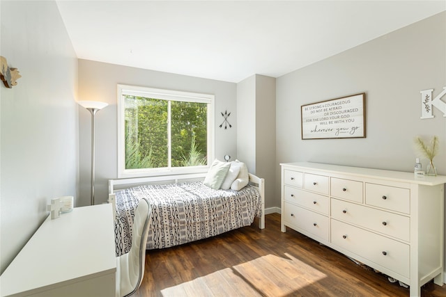 bedroom with dark wood-type flooring and baseboards