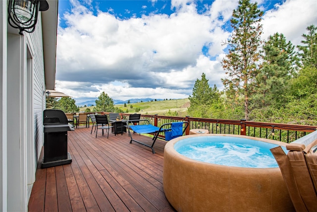 wooden terrace with a mountain view and area for grilling