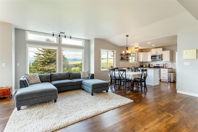 living area with dark wood-style flooring, a chandelier, recessed lighting, baseboards, and vaulted ceiling
