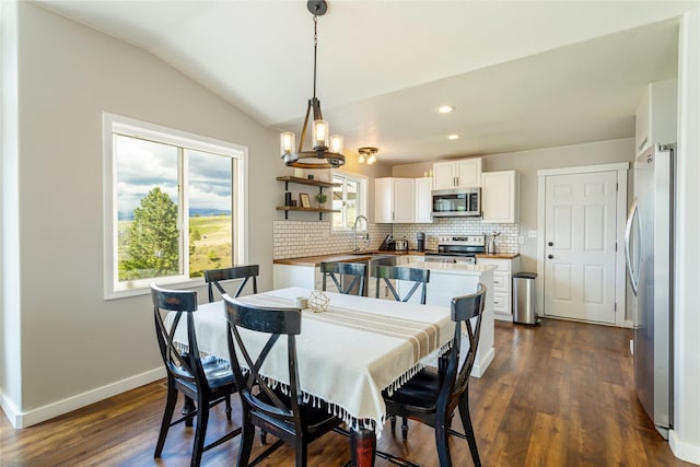 dining room with vaulted ceiling, dark wood-type flooring, baseboards, recessed lighting, and a chandelier