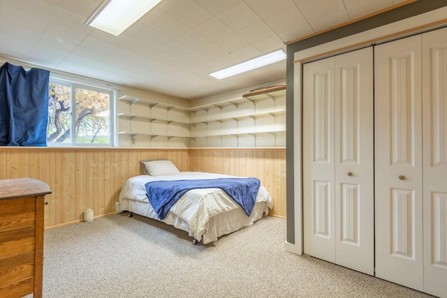 500 Geddis St, Helena, MT 59601 - bedroom featuring wood walls, carpet floors, a closet, and baseboards