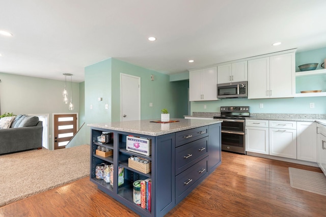 500 Geddis St, Helena, MT 59601 - kitchen featuring open shelves, stainless steel appliances, white cabinetry, wood finished floors, and a center island