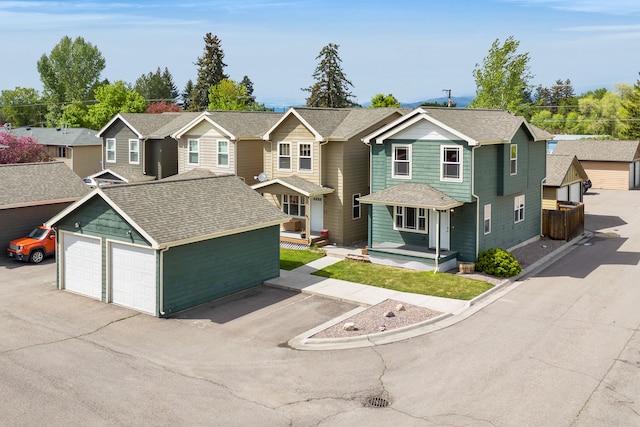traditional-style home with an outbuilding, roof with shingles, and a garage