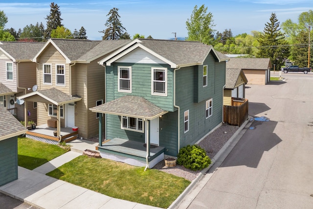 view of front of property featuring roof with shingles and a garage