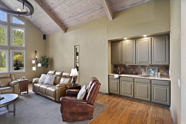 215 Browns Gulch Rd, Kalispell, MT 59901 - living area featuring wood ceiling with exposed beams, a textured wall, light wood finished floors, and high vaulted ceiling