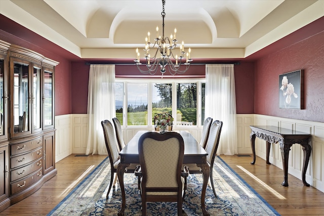 215 Browns Gulch Rd, Kalispell, MT 59901 - dining space with a chandelier, a decorative wall, wainscoting, healthy amount of natural light, and wood finished floors