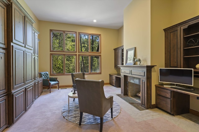 215 Browns Gulch Rd, Kalispell, MT 59901 - dining room featuring light carpet, a fireplace, a desk, baseboards, and a towering ceiling