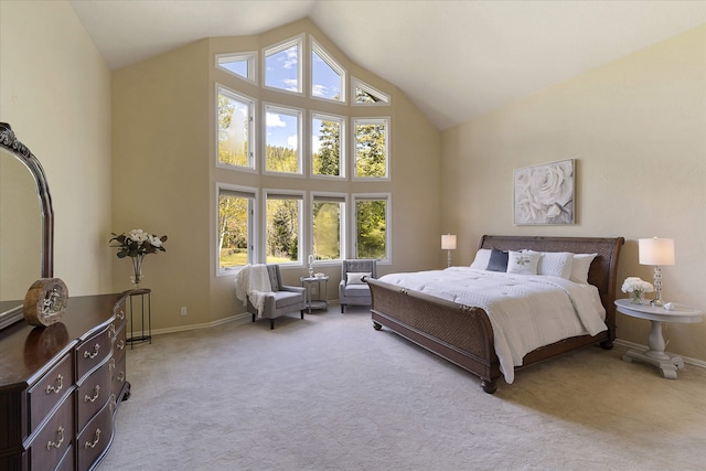 215 Browns Gulch Rd, Kalispell, MT 59901 - bedroom featuring high vaulted ceiling, multiple windows, light colored carpet, and baseboards
