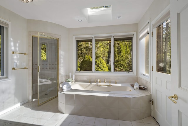 215 Browns Gulch Rd, Kalispell, MT 59901 - full bath with a skylight, tile patterned floors, a bath, and plenty of natural light
