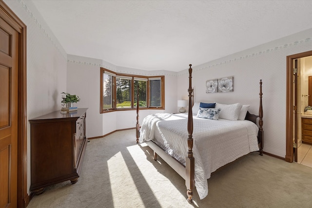 215 Browns Gulch Rd, Kalispell, MT 59901 - bedroom with light colored carpet, baseboards, ensuite bath, and wallpapered walls