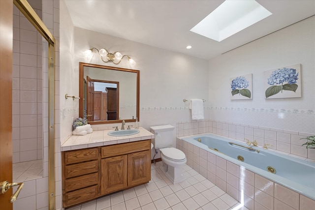 215 Browns Gulch Rd, Kalispell, MT 59901 - full bath featuring a skylight, toilet, a whirlpool tub, tile patterned flooring, and vanity