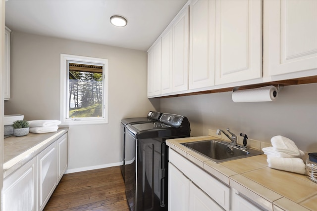 215 Browns Gulch Rd, Kalispell, MT 59901 - laundry area featuring washer and clothes dryer, dark wood-style flooring, cabinet space, and baseboards