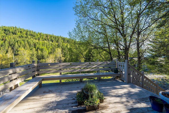 215 Browns Gulch Rd, Kalispell, MT 59901 - wooden deck featuring a wooded view
