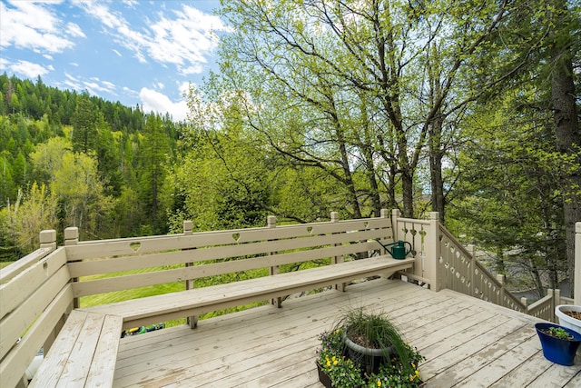 215 Browns Gulch Rd, Kalispell, MT 59901 - wooden terrace with a wooded view