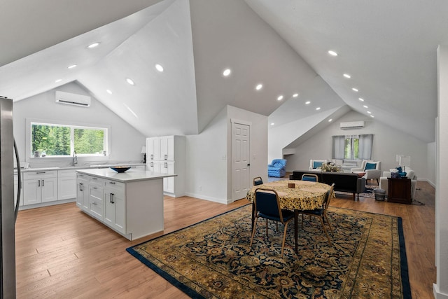 215 Browns Gulch Rd, Kalispell, MT 59901 - dining space with lofted ceiling, an AC wall unit, light wood-style flooring, and recessed lighting