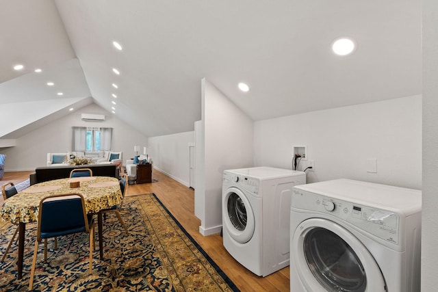 215 Browns Gulch Rd, Kalispell, MT 59901 - laundry area with washing machine and clothes dryer, light wood-style floors, an AC wall unit, recessed lighting, and baseboards