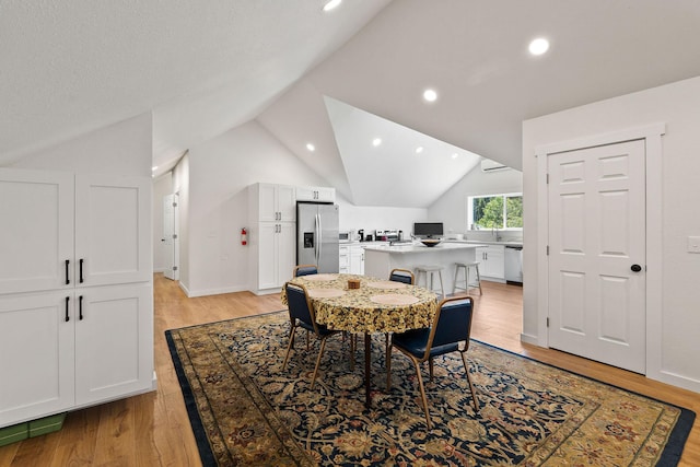 215 Browns Gulch Rd, Kalispell, MT 59901 - dining room featuring vaulted ceiling, light wood-style floors, and recessed lighting
