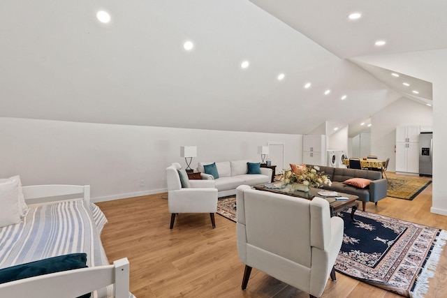 215 Browns Gulch Rd, Kalispell, MT 59901 - living room with light wood-style floors, lofted ceiling, recessed lighting, baseboards, and washer / dryer