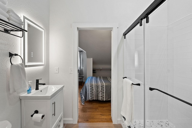 215 Browns Gulch Rd, Kalispell, MT 59901 - ensuite bathroom featuring wood finished floors, vanity, a shower stall, and a textured wall