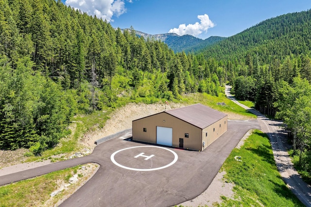 215 Browns Gulch Rd, Kalispell, MT 59901 - aerial view of property and surrounding area featuring a forest and a mountainous background