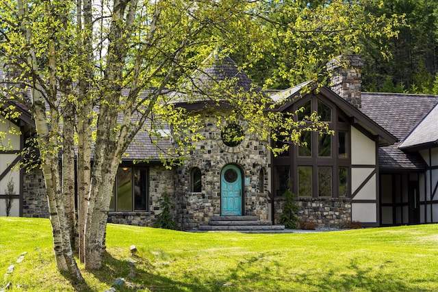 215 Browns Gulch Rd, Kalispell, MT 59901 - english style home featuring stone siding, stucco siding, a front lawn, and a chimney