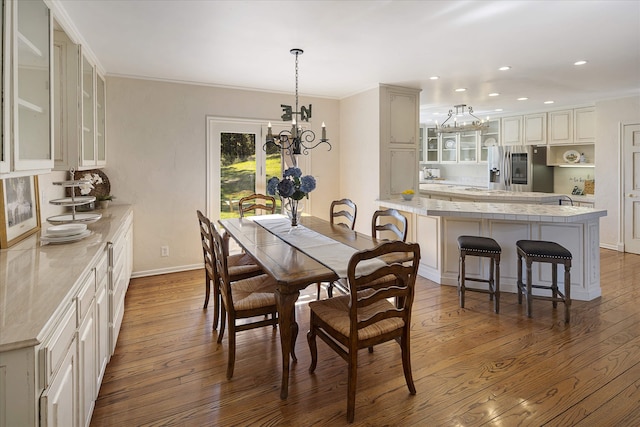 215 Browns Gulch Rd, Kalispell, MT 59901 - dining space featuring a chandelier, hardwood / wood-style flooring, recessed lighting, baseboards, and ornamental molding