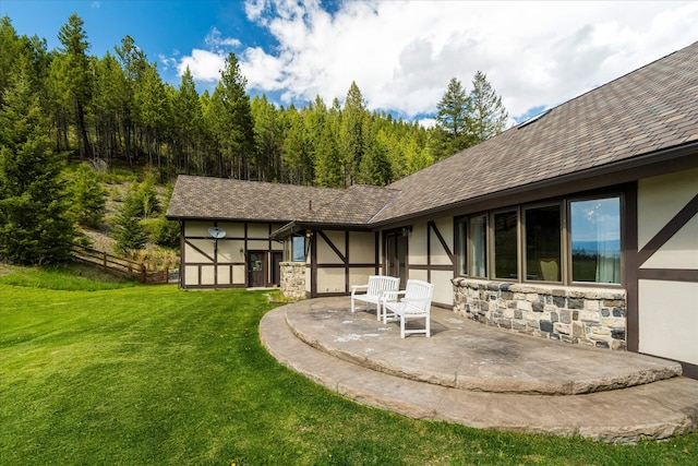 215 Browns Gulch Rd, Kalispell, MT 59901 - back of property with stucco siding, stone siding, and a patio area