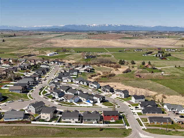 aerial view of property's location with a mountain backdrop and nearby suburban area