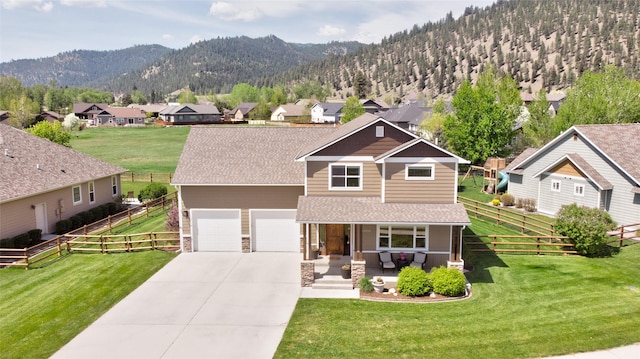 11818 Stella Blue Dr, Lolo, MT 59847 - view of front of property with covered porch, a residential view, a mountain view, concrete driveway, and a shingled roof