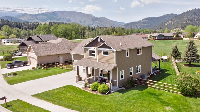 11818 Stella Blue Dr, Lolo, MT 59847 - view of front of property with a porch, driveway, a mountain view, central air condition unit, and a shingled roof