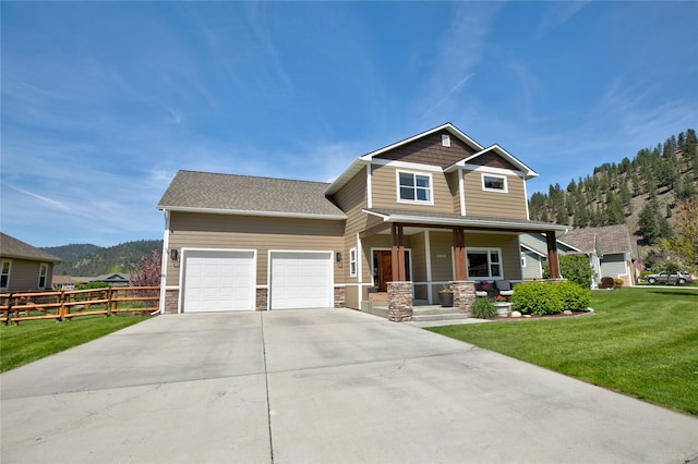 11818 Stella Blue Dr, Lolo, MT 59847 - craftsman-style home with covered porch, a garage, concrete driveway, stone siding, and a mountain view