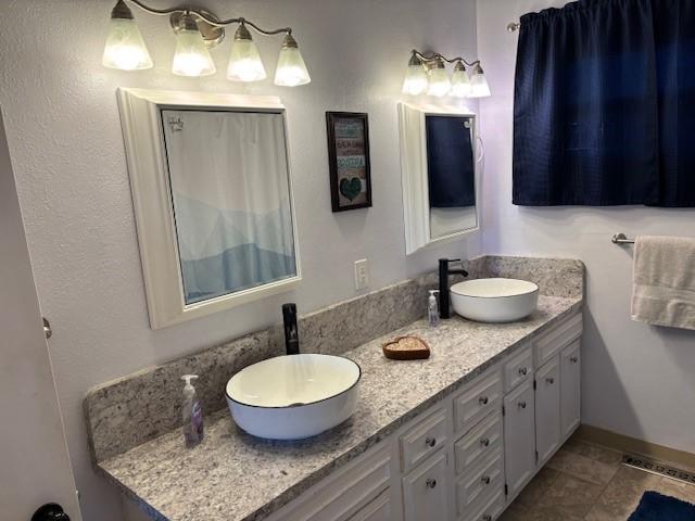 330 2nd St S, Shelby, MT 59474 - bathroom featuring double vanity and tile patterned floors