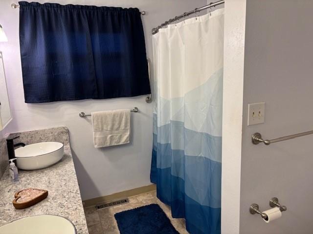 330 2nd St S, Shelby, MT 59474 - bathroom with tile patterned floors, a shower with shower curtain, and vanity
