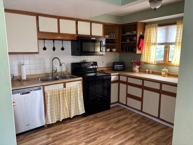 330 2nd St S, Shelby, MT 59474 - kitchen featuring black appliances, a sink, tasteful backsplash, and light countertops