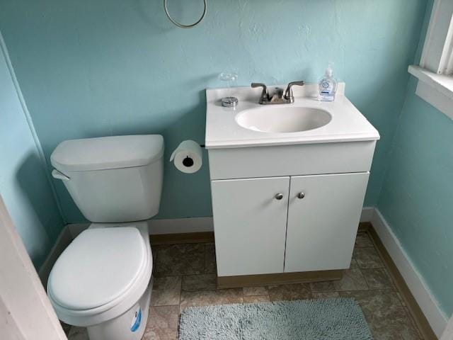330 2nd St S, Shelby, MT 59474 - half bathroom with vanity, toilet, and baseboards
