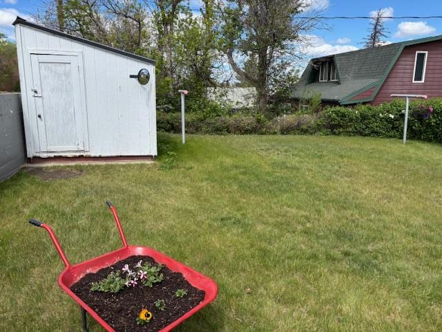 330 2nd St S, Shelby, MT 59474 - view of green lawn with a storage shed and an outdoor structure