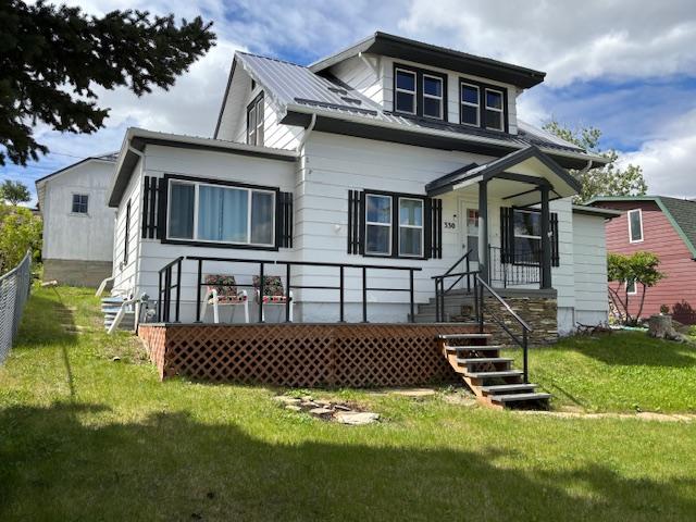 330 2nd St S, Shelby, MT 59474 - view of front of home featuring a front lawn and metal roof