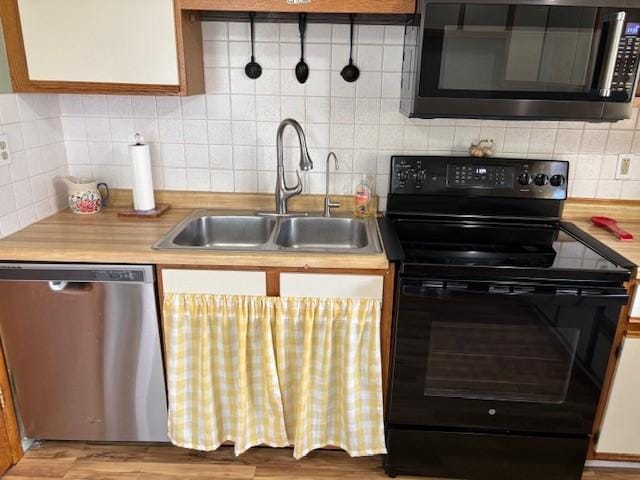 330 2nd St S, Shelby, MT 59474 - kitchen with black electric range oven, dishwasher, a sink, backsplash, and light countertops
