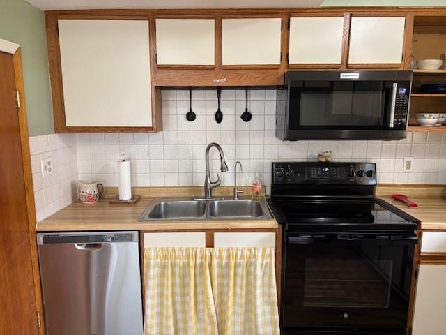 330 2nd St S, Shelby, MT 59474 - kitchen with dishwasher, black electric range, a sink, light countertops, and tasteful backsplash